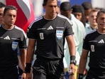 Referee Facundo Tello, center, assistant referee Juan Pablo Belatti, left, and assistant referee Gabriel Chade, all from Argentina, lead the teams on to the field before the World Cup quarterfinal soccer match between France and Morocco. (AP Photo/Charles Krupa) Referee Facundo Tello, center, assistant referee Juan Pablo Belatti, left, and assistant referee Gabriel Chade, all from Argentina, lead the teams on to the field before the World Cup quarterfinal soccer match between France and Morocco. (AP Photo/Charles Krupa)