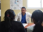 A Cuban doctor speaking with patients in Guatemala, where more than 400 Cuban personnel are expected to leave by year’s end.