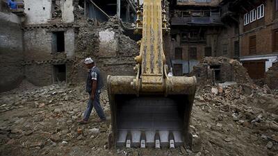 A-man-walks-past-an-excavator-parked-near-collapsed-houses-that-were-damaged-during-the-earthquake-in-Bhaktapur-Two-months-after-massive-twin-earthquakes-killed-8-897-people-in-Nepal-nearly-three-million-survivors-many-in-mountainous-hard-to-reach-areas-still-needed-shelter-food-and-basic-medical-care-as-the-yearly-monsoon-bore-down-on-the-Himalayan-nation-the-UN-said-in-a-report-Reuters-Photo A-man-walks-past-an-excavator-parked-near-collapsed-houses-that-were-damaged-during-the-earthquake-in-Bhaktapur-Two-months-after-massive-twin-earthquakes-killed-8-897-people-in-Nepal-nearly-three-million-survivors-many-in-mountainous-hard-to-reach-areas-still-needed-shelter-food-and-basic-medical-care-as-the-yearly-monsoon-bore-down-on-the-Himalayan-nation-the-UN-said-in-a-report-Reuters-Photo
