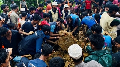 Rohingya refugees works to rescue victims from a landslide spot at a Rohingya Refugee Camp following continuous torrential rain, in Cox’s Bazar, Bangladesh. (REUTERS)