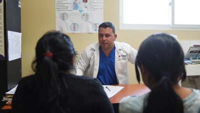 A Cuban doctor speaking with patients in Guatemala, where more than 400 Cuban personnel are expected to leave by year’s end.