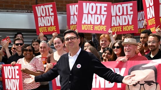 Labour party candidate Andy Burnham addresses supporters outside the Labour party campaign office in Ashton in Makerfield, northwest England. (AFP)