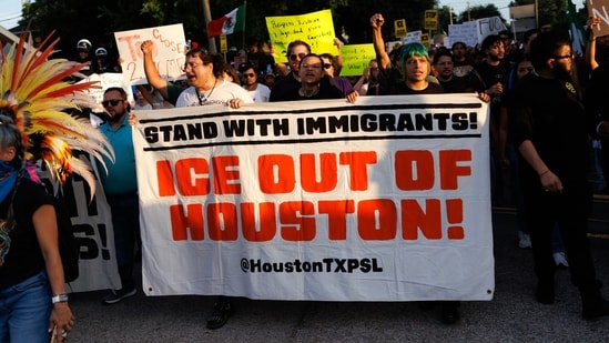 People march through the streets during a vigil for Lorenzo Salgado Araujo, a Mexican national fatally shot by a federal immigration agent a day prior, Wednesday, July 8, 2026, in Houston. (AP Photo/Mark Felix) (AP Photo/Mark Felix)