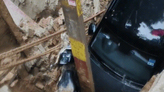A parked car and a scooter plunged into the pit, while a nearby electricity pole tilted towards the crater. (PTI, HT Photos and X@Ruchirdilse)