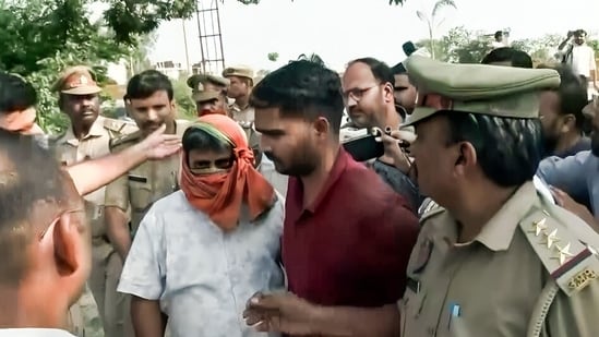 Police take three jailed accused in Ram Temple donations embezzlement case Anukalp Mishra, Lavkush Mishra and Karunesh Pandey from 14 Kosi Parikrama Marg for further proceedings, in Ayodhya on Wednesday. (ANI Video Grab)