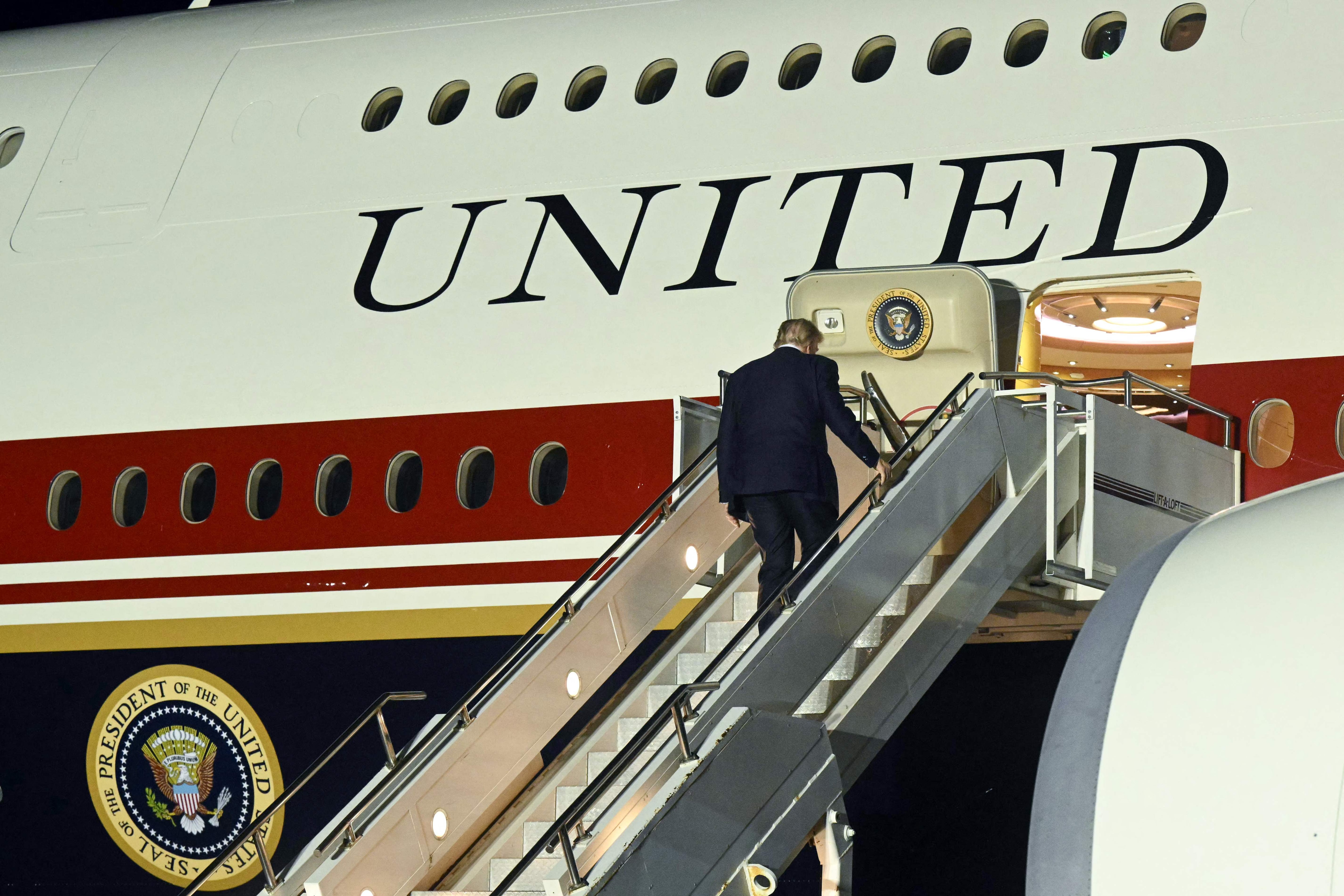 US President Donald Trump boards the new Air Force One after changing planes at Royal Air Force (RAF) Mildenhall in Mildenhall, eastern England, on July 8, 2026. (AFP)