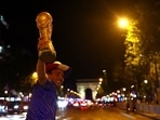 France fan celebrates with a replica World Cup trophy at Champs-Elysees after the match REUTERS/Abdul Saboor