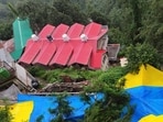 A landslide occurred near Sanjauli College in Shimla on Saturday morning, endangering several houses. The area has been covered with tarpaulin to prevent further slippage. (Deepak Sansta/HT)