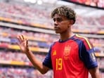 Spain's Lamine Yamal waves as he walks off the pitch. 