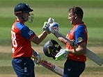 England's Jos Buttler (R) celebrated his 51-ball 100 with England's Harry Brook (L) during the fifth T20I.