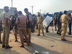 Police personnel stand guard as supporters of senior BJP leader Narottam Mishra clashed with police and blocked a national highway in Datia, Madhya Pradesh.