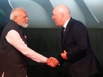 Prime Minister Narendra Modi (L) and New Zealand Prime Minister Christopher Luxon (R) shake hands during the New Zealand/India Business Event in Auckland.