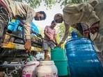 Residents seen collecting water from a tanker in Geeta Colony in New Delhi, India.