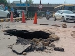 The cave-in, reported on the cement concrete (CC) road in Sector 31 at around 12.30pm, posed a safety risk for commuters during peak hours. (HT)
