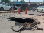 The cave-in, reported on the cement concrete (CC) road in Sector 31 at around 12.30pm, posed a safety risk for commuters during peak hours. (HT)