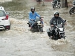Vehicles wade through waterlogged Shivpuri locality after heavy rain in Patna on Saturday. (Santosh Kumar/HT)