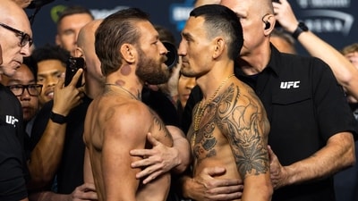 Conor McGregor (left) faces off with Max Holloway during weigh ins for UFC 329 at T-Mobile Arena. (IMAGN IMAGES via Reuters Connect)