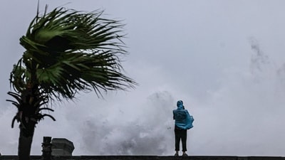 A person looks on as large waves crash against the coast as Typhoon Bavi passes off northeastern Taiwan. (AFP) A person looks on as large waves crash against the coast as Typhoon Bavi passes off northeastern Taiwan. (AFP)