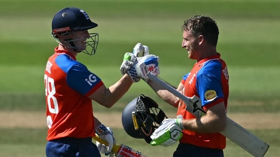 England's Jos Buttler (R) celebrated his 51-ball 100 with England's Harry Brook (L) during the fifth T20I. (AFP)