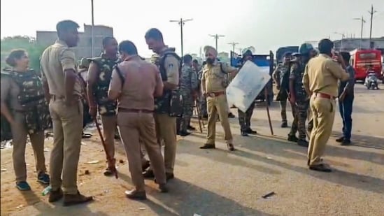 Police personnel stand guard as supporters of senior BJP leader Narottam Mishra clashed with police and blocked a national highway in Datia, Madhya Pradesh. (PTI)
