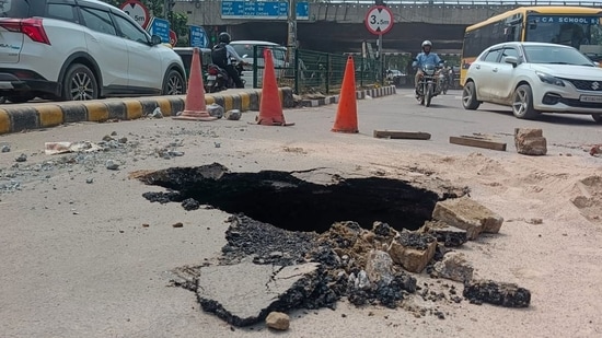 The cave-in, reported on the cement concrete (CC) road in Sector 31 at around 12.30pm, posed a safety risk for commuters during peak hours. (HT)