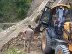 A landslide being cleared over a road in Champawat district on Sunday. (HT Photo)