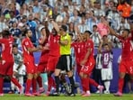 Switzerland's players argue referee Joao Pinheiro, of Portugal, gives a second yellow card to Breel Embolo (7) during the World Cup quarterfinal against Argentina