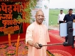 CM Yogi Adityanath clicks a selfie with the sapling he planted to launch the plantation campaign on Sunday. (HT)