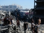Palestinians gather at the site of an Israeli military drone strike on a blacksmith shop in Gaza City's Sabra neighbourhood on Sunday, July 12, 2026. The strike killed at least four Palestinians and wounded another, according to officials at Shifa Hospital, where the casualties were taken.
