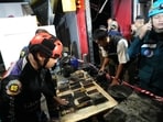 Mobile phones of victims of a fire are recovered in Bangkok, Thailand, Monday, July 13, 2026.
