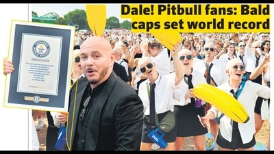 Rapper Pitbull shows the Guinness World Record as his fans, flaunting bald caps, rejoice at Hyde Park in London. (Photos: AFP) Rapper Pitbull shows the Guinness World Record as his fans, flaunting bald caps, rejoice at Hyde Park in London. (Photos: AFP)