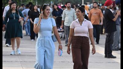 Visitors taking a stroll at Sukhna Lake in Chandigarh on Sunday. (Keshav Singh/HT)
