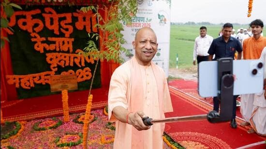 CM Yogi Adityanath clicks a selfie with the sapling he planted to launch the plantation campaign on Sunday. (HT)
