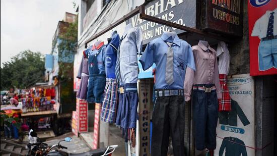 New Delhi, India - August 16, 2020: School uniforms hanged outside a shop in Gandhi Nagar, New Delhi, India, on Sunday, August 16, 2020. School uniforms manufacturers and sellers are facing many problems as schools are closed amid the Covid-19 pandemic and uniforms are stocked in godowns and shops. (Photo by Biplov Bhuyan/ Hindustan Times) **To go with Manoj Sharma's story (Biplov Bhuyan/HT PHOTO)