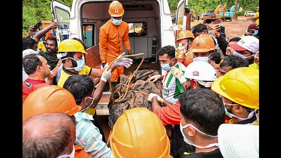 People carry the mortal remains of Vikram Rana, 58, a construction manager from Himachal Pradesh, recovered during a search operation following the landslide on Tuesday at the tunnel project site in Kalladi, Wayanad. (PTI)