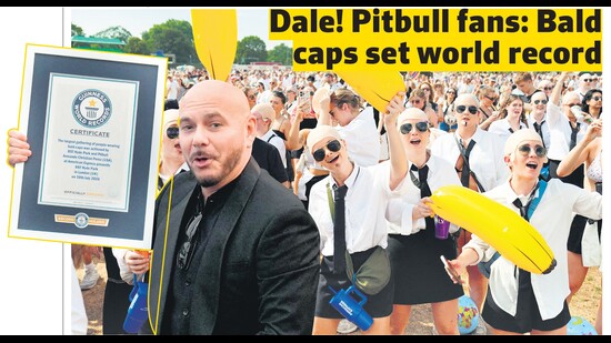 Rapper Pitbull shows the Guinness World Record as his fans, flaunting bald caps, rejoice at Hyde Park in London. (Photos: AFP)