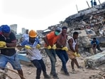 Volunteers pull a rope to remove a debris from a collapsed building by earthquakes in La Guaira, Venezuela, Sunday, July 12, 2026.