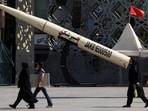 People walk next to a symbolic mockup of an Iranian missile at Imam Hussein Square in Tehran, Iran, July 12, 2026. 
