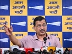 AAP National Convenor Arvind Kejriwal interacts with mechanics and vehicle owners at a service centre in Delhi while discussing concerns related to E20-blended petrol.