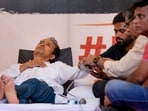 Climate activist Sonam Wangchuk being attended by a medical professional as Cockroach Janata Party (CJP) founder Abhijeet Dipke looks on during a hunger strike by CJP,
