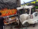 People gather after a car crashed into a parked truck on the National Highway at Ruma in Kanpur on Monday. (PTI)