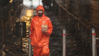 A gig worker wades through a waterlogged subway. (REUTERS)