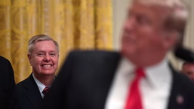 File photo of Lindsey Graham listening as President Donald Trump speaks. (AP Photo)