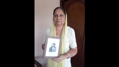 Paramjit Kaur Khalra, wife of human rights activist Jaswant Singh Khalra, showing his photo. (HT photo) Paramjit Kaur Khalra, wife of human rights activist Jaswant Singh Khalra, showing his photo. (HT photo)