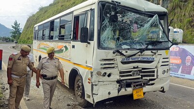 People around the bus that was damaged in pile-up in Ramban on Monday. (ANI Video Grab)