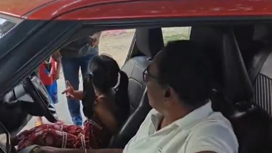 A Hyderabad cop was suspended after allowing his granddaughter, a minor, to drive a car on a busy road(X/@CYBTRAFFIC)