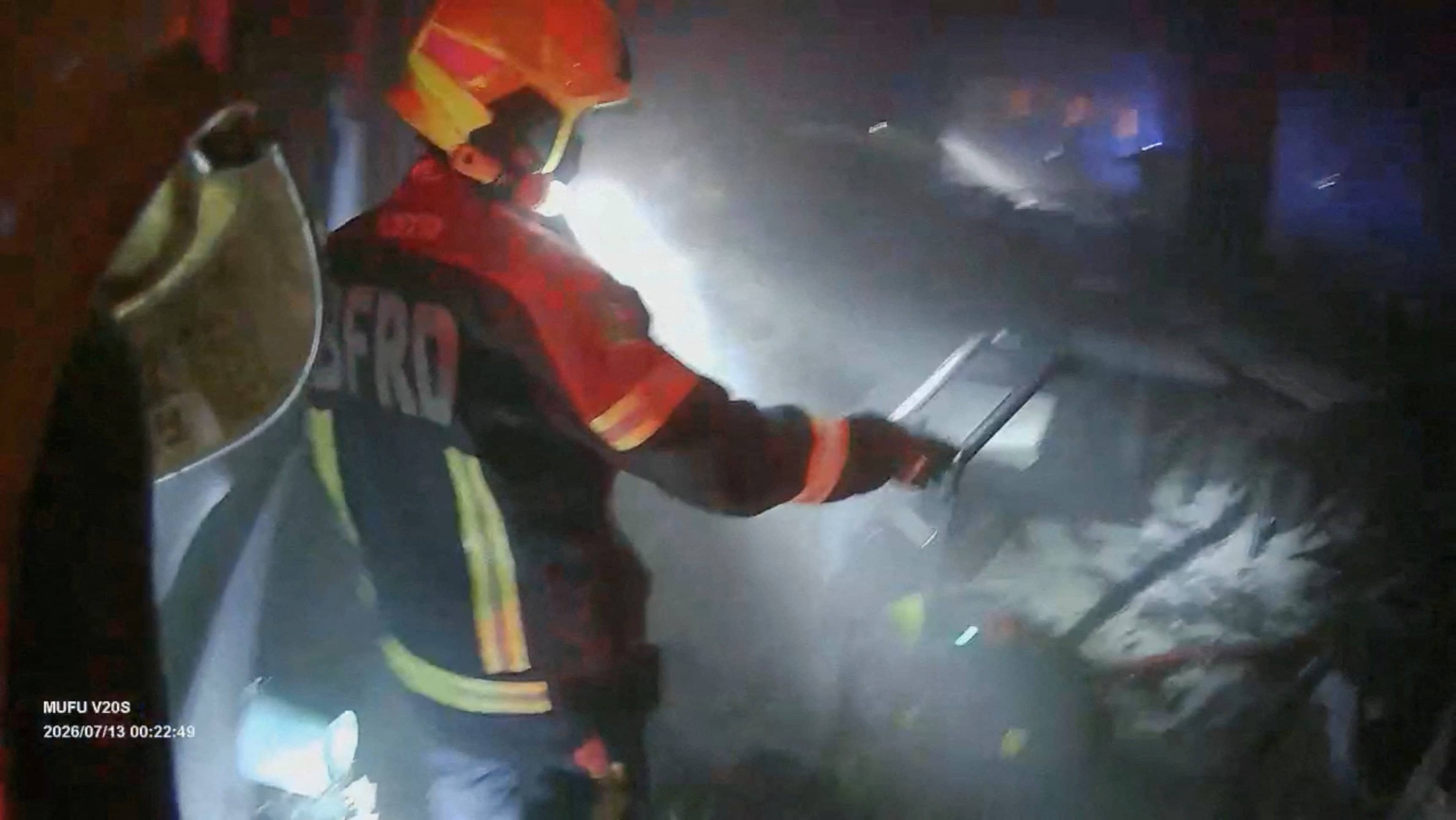 A rescue worker inspects the site of a deadly fire at a pub in Bangkok, Thailand. (REUTERS)