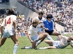 (FILES) Argentine legend Diego Maradona (centre) dribbles past three England defenders on June 22, 1986, in Mexico City during the World Cup quarterfinal. Maradona scored two goals, including the infamous ‘Hand of God’ goal. (AFP)