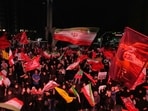 Pro-government demonstrators wave Iranian and religious flags in a gathering commemorating the late Iranian Supreme Leader Ayatollah Ali Khamenei, shown in a flag at right, at a square in Tehran, Saturday, July 11, 2026. (AP Photo/Vahid Salemi)