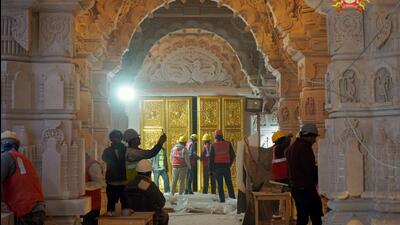 Ayodhya, Jan 15 (ANI): A view of the 'golden door' Is being installed at the Ram temple in Ayodhya on Monday. This door is about 12 feet high and 8 feet wide. 13 more doors will be installed in the coming 3 days. These doors are being installed on the upper floor of the sanctum sanctorum. A total of 46 doors will be installed in the Ram temple, out of which 42 will be coated with 100 kg gold. (ANI Photo) (Ram Janmbhoomi Teerth Kshetra Tr) Ayodhya, Jan 15 (ANI): A view of the 'golden door' Is being installed at the Ram temple in Ayodhya on Monday. This door is about 12 feet high and 8 feet wide. 13 more doors will be installed in the coming 3 days. These doors are being installed on the upper floor of the sanctum sanctorum. A total of 46 doors will be installed in the Ram temple, out of which 42 will be coated with 100 kg gold. (ANI Photo) (Ram Janmbhoomi Teerth Kshetra Tr)